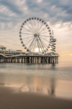 Ferris wheel at sunset on the pier at the beach, The Hague, Netherlands