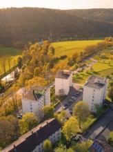 Residential buildings in an urban landscape next to forests and fields in the sunlight, Nagold,