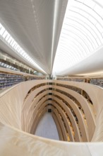 Large, modern library with spiral-shaped architecture and bright glass roof, University Law