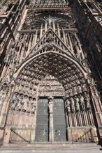 Strasbourg, France, September 2023: Gothic style entrance door with tympanum of west facade of