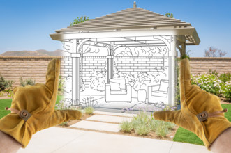 Male Contractor Hands Framing Drawing Section of Custom Pergola Patio Cover Design Drawing