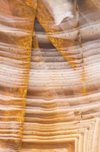 Close-up macro shot of Pilbara agate from Western Australia, showcasing its warm orange, cream, and