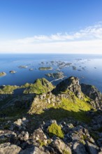View of numerous small rocky islands with houses, at the summit of Festvågtind, view of