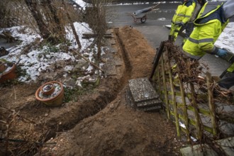 Excavation to lay Telekom's fiber optic cables in a residential building, Eckental, Middle