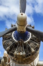 Close-up of an aircraft propeller against a blue sky, technical details visible, The propeller of