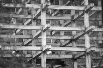Black and white photo showcasing the intricate geometric pattern of concrete beams and pillars in