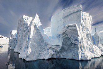 Majestic, towering icebergs with sharp edges against a dark sky, icebergs in the landscape of the