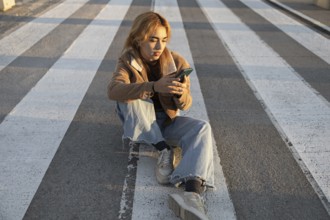 A Mixed-race woman sits quietly at a crosswalk, absorbed in her smartphone Natural light enhances