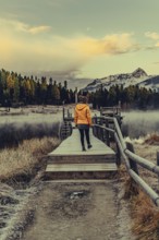 Young woman at Lake Staz near Sankt Moritz in the Engadine in Switzerland. Morning atmosphere with