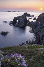 Coastal landscape at Land's End. The rock Enys Dodnan Arch with rock gate. In the foreground,