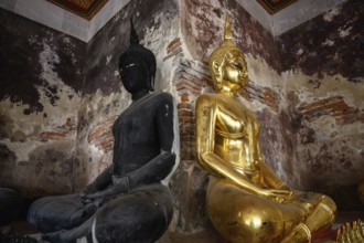 Bangkok, Thailand. February 20th 2025. A black and a gold Buddha statue on display in the The Wat