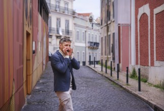 Man musician in a blue blazer and white sweater playing blues on a harmonica with eyes closed,
