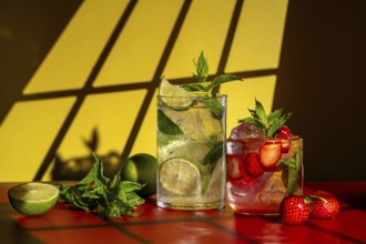 Glasses of classic mojito with lime and mint, and strawberry mojito featuring fresh strawberries,