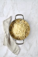 Overhead view of casserole with noodles and chopped champignon, chanterelles, oyster mushrooms and