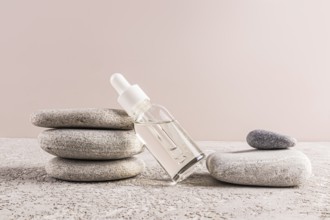 A minimalistic scene featuring a clear glass serum bottle on stone layers, embodying harmony and