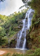 Stunning waterfall among the dense vegetation and rocks of the rainforest in the state of Minas