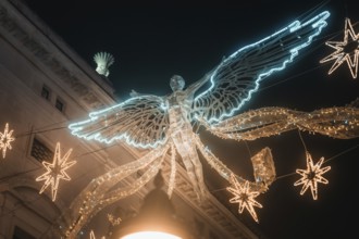 Shining angel and stars form festive Christmas decoration, New Year's Eve London, United Kingdom