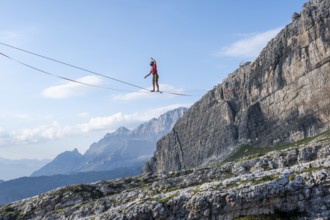 Slackliner in the mountains, mountain peaks of the Brenta Mountains, at Refugio Francis Fox