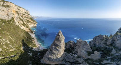 Picturesque rocky coast, cliffs with L'Aguglia pinnacle, blue sea and Cala Goloritzé beach, aerial