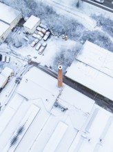 Factory district with striking chimney, completely covered in snow, Nagold, Black Forest, Germany