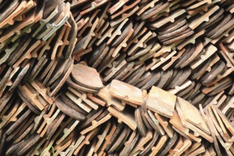 Old roof tiles stored on stockpiles for reuse on historic buildings and heritage-protected houses,