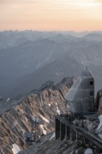 Mountain station of the Tyrolean Zugspitze railway at the summit of the Zugspitze, at sunset,