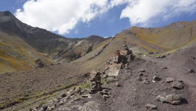 Rocky mountain landscape with rock formations under cloudy sky, trekking at Stok La Pass in Ladakh,