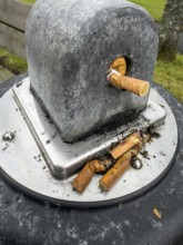Public ashtray with cigarette butts outdoors in Ystad, Skåne County, Sweden, Scandinavia