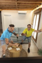 Friends reacting with excitement after a goal while watching a live sports match at home.