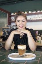 Korean woman, 47, in her café, Yeosu, Jeollanam-do Province, South Korea