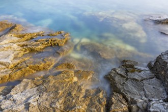 Crystal clear and turquoise water on the beach of Ustrine Bay on a sunny day on the island of Cres,