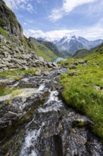 Mountain stream in picturesque mountain landscape, view of mountain lake Lac du Louvie and