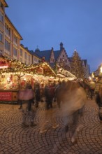 December 22, 2025, Frankfurt Christmas Market on Roemerberg at twilight. Traditional wooden stalls