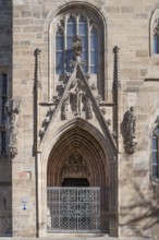 Gothic side entrance portal with the tympanum of the Entombment of Mary, St Andrew's Church,