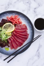 Tuna sashimi, with side dish, on a marble table, homemade, no people