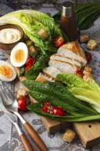 A vibrant image showing fresh Caesar salad ingredients, including romaine lettuce, grilled chicken,