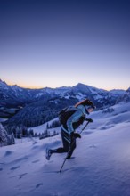 Hiking in the snow in the snow-covered winder landscape in the Alps at Neunerköpfle in the