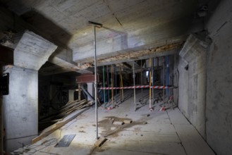 A detailed view of a construction site showing a partially completed structure. Wooden planks,