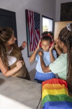 A loving lesbian couple with their child, surrounded by symbols of pride and diversity. They embody