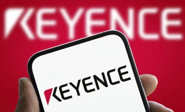 Keyence logo is displayed on smartphone. Keyence is a Japanese company that manufactures automation