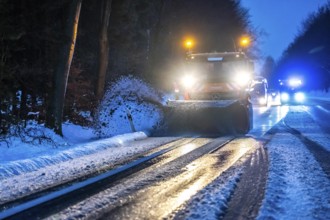 Winter service, spreader and snow plough in use, clears snow and slush from a regional road,