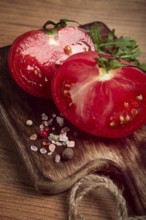 Sliced tomato, on a wooden chopping board, food background, no people