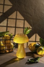 A refreshing lemon drink served in an artistic glass, adorned with green leaves and surrounded by