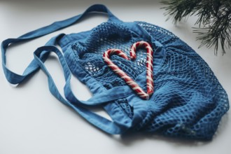 A striking image showcasing heart-shaped candy canes nestled within a vibrant blue string bag,