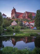 Havelberg Cathedral of St Mary at dusk, reflection in the moat, brick architecture, Hanseatic town
