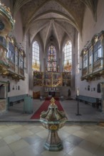 Chancel with baptismal font of the Protestant Church of St. Mary, baroqueised in the 18th century,