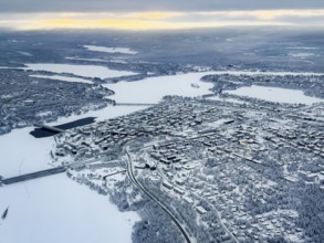 View of the snowy town of Rovaniemi with the Kemijoki river, in winter, aerial view, Finland