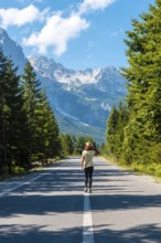A young girl walking on the road in the Valbona valley, Theth national park, Albanian Alps, Valbona