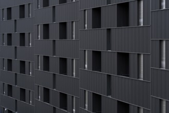 Modern building featuring a distinct, sustainable architectural style with vertically aligned,