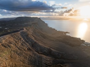 Cliffs by the sea in evening light, steep cliffs on the coast near the Mirador del Porrito, aerial
